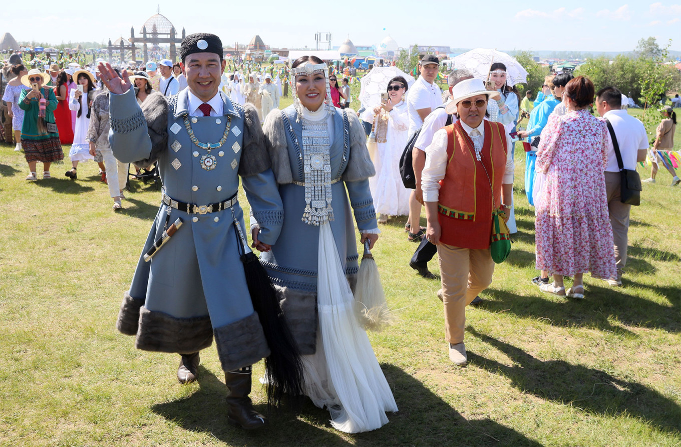 Aisen Nikolayev (L), the head of the republic of Sakha, and his wife Lyudmila attend the opening ceremony of Ysyakh Tuimaady. Vadim Skryabin / TASS